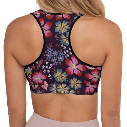A model wearing the Green Park Performance Bra in blue, pink, yellow floral pattern on burgundy background