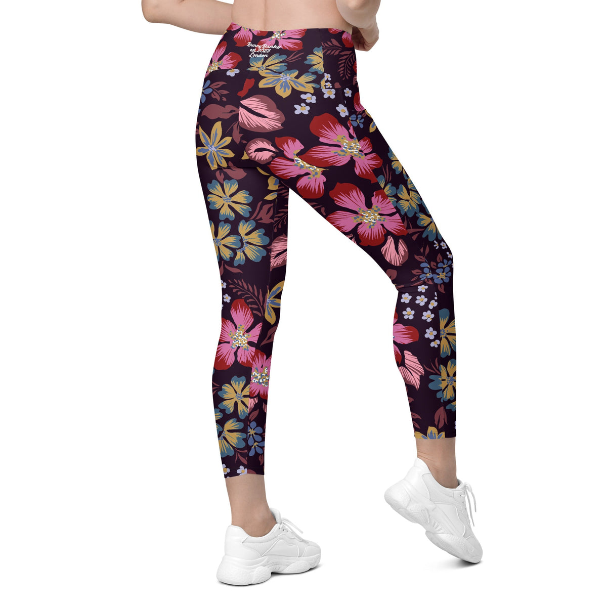 model wearing the Green Park  sculpt leggings in blue, pink, yellow floral pattern on burgundy background