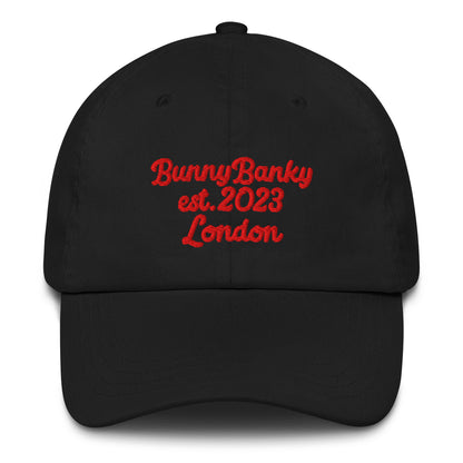 A close up of The Heritage Cap in black showing the heritage branded signature embroidered in red