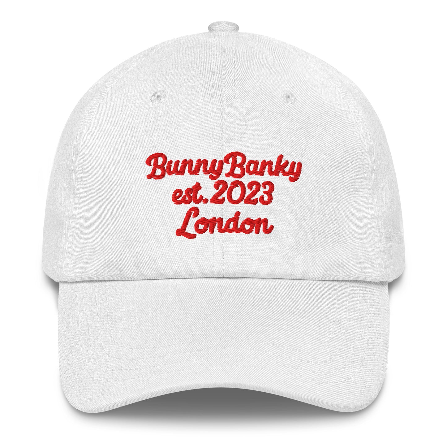 A close up of The Heritage Cap in white showing the heritage branded signature embroidered in red