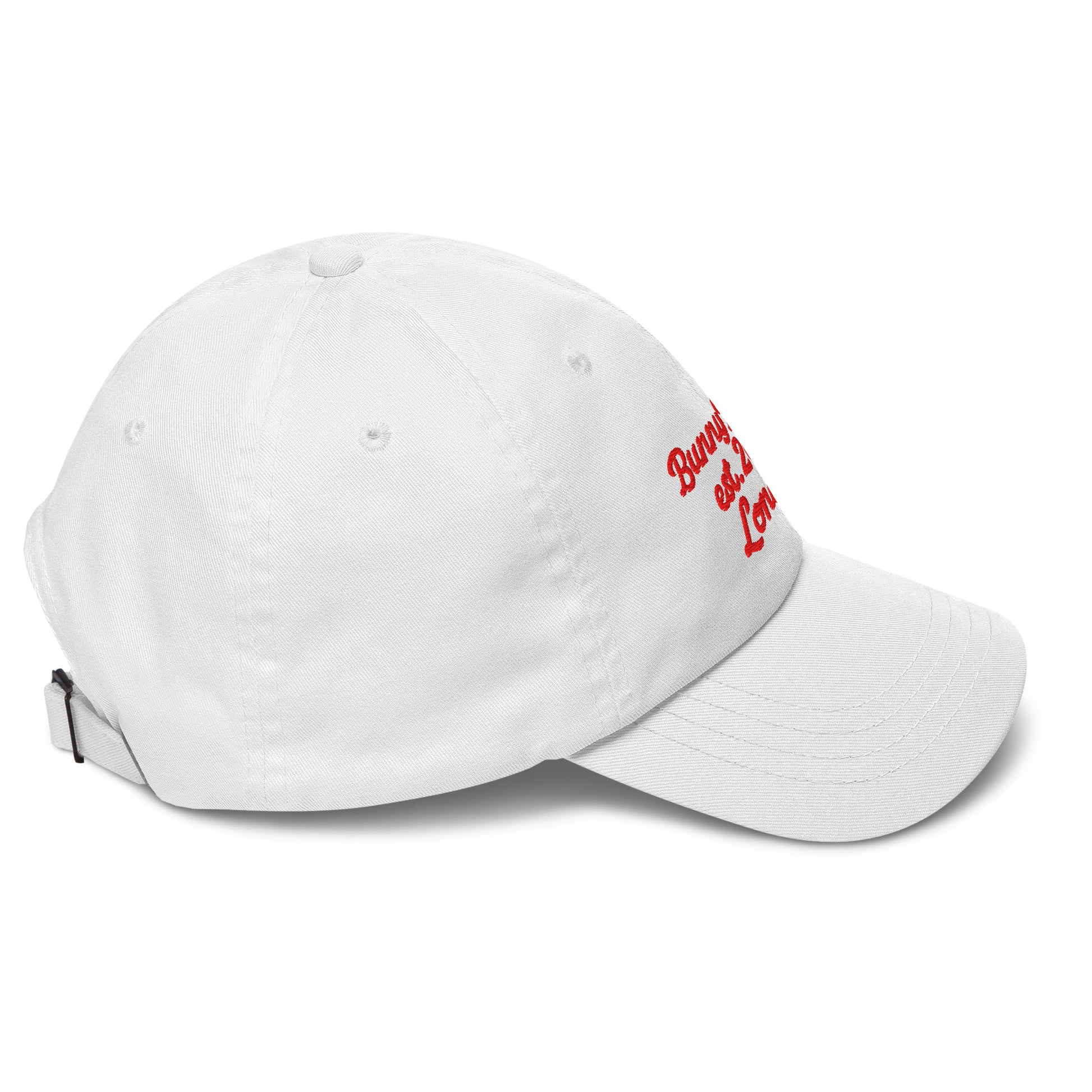 A close up of The Heritage Cap in white showing the heritage branded signature embroidered in red