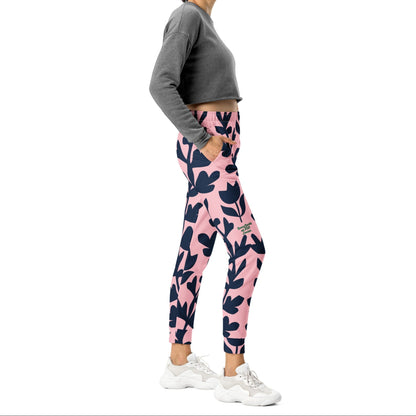 A model wearing The Kensington Glide Joggers, showing the slim fit and the bold, high-contrast pink and blue oversized floral print.