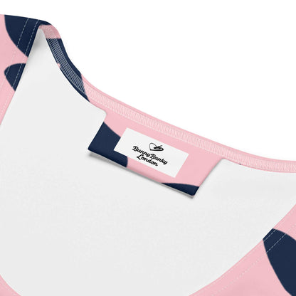 A close up of the Kensington Performance Tank featuring navy blue floral pattern on soft pink fabric inside branded label.