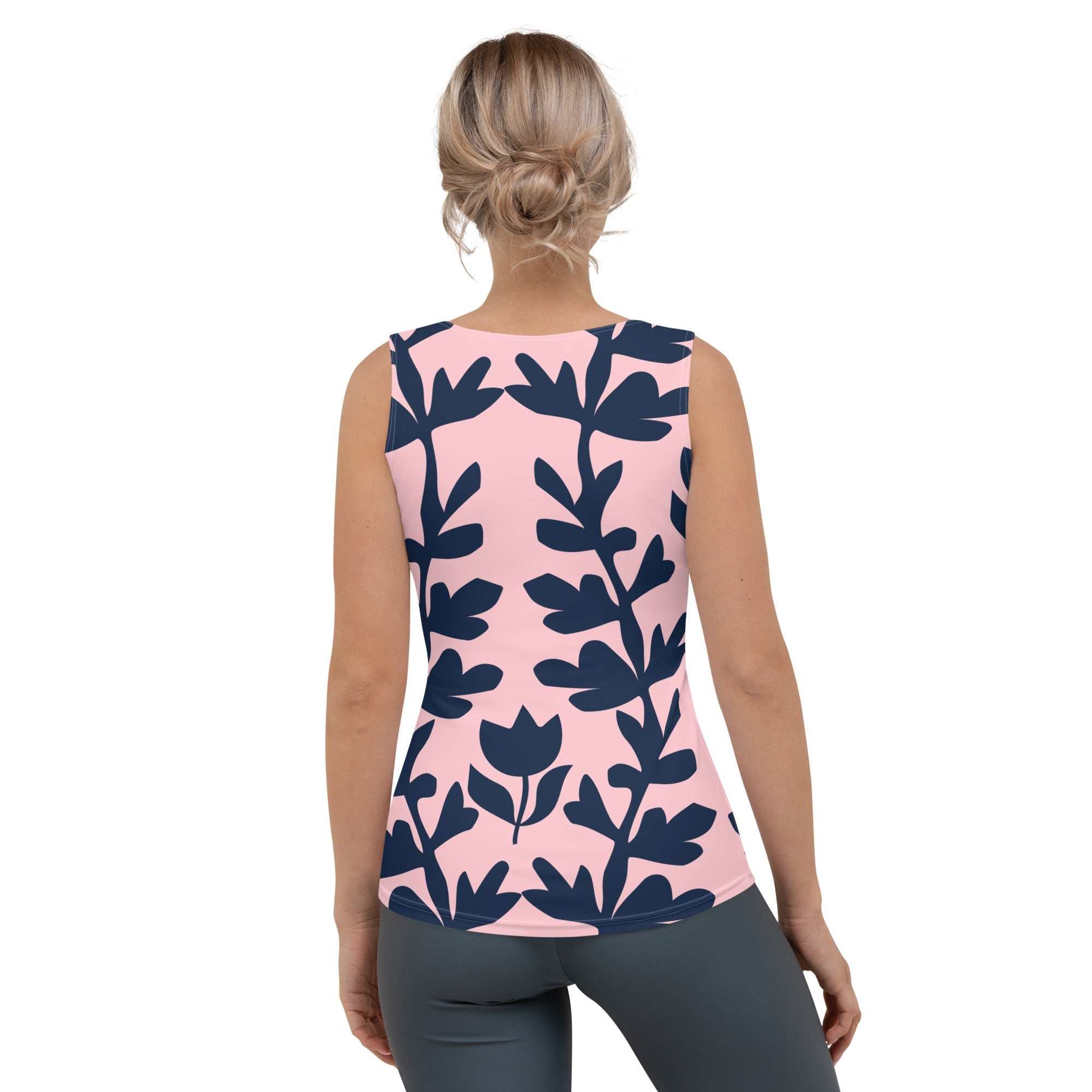 Model wearing the Kensington Performance Tank featuring navy blue floral pattern on soft pink fabric.