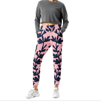 A model wearing The Kensington Glide Joggers, showing the slim fit and the bold, high-contrast pink and blue oversized floral print.