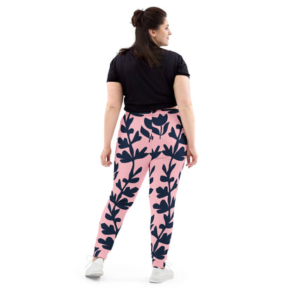 A model wearing The Kensington Glide Joggers, showing the slim fit and the bold, high-contrast pink and blue oversized floral print.