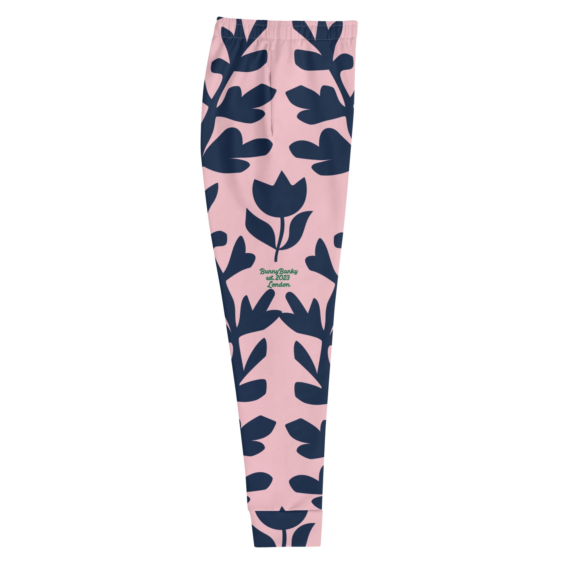 A close up of  The Kensington Glide Joggers, showing the slim fit and the bold, high-contrast pink and blue oversized floral print.