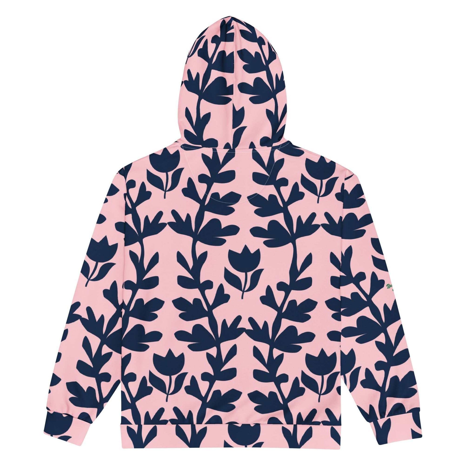 A model wearing The Kensington Zip Hoodie, showing the full-zip closure and the oversized pink and blue floral print across the recycled polyester fabric.