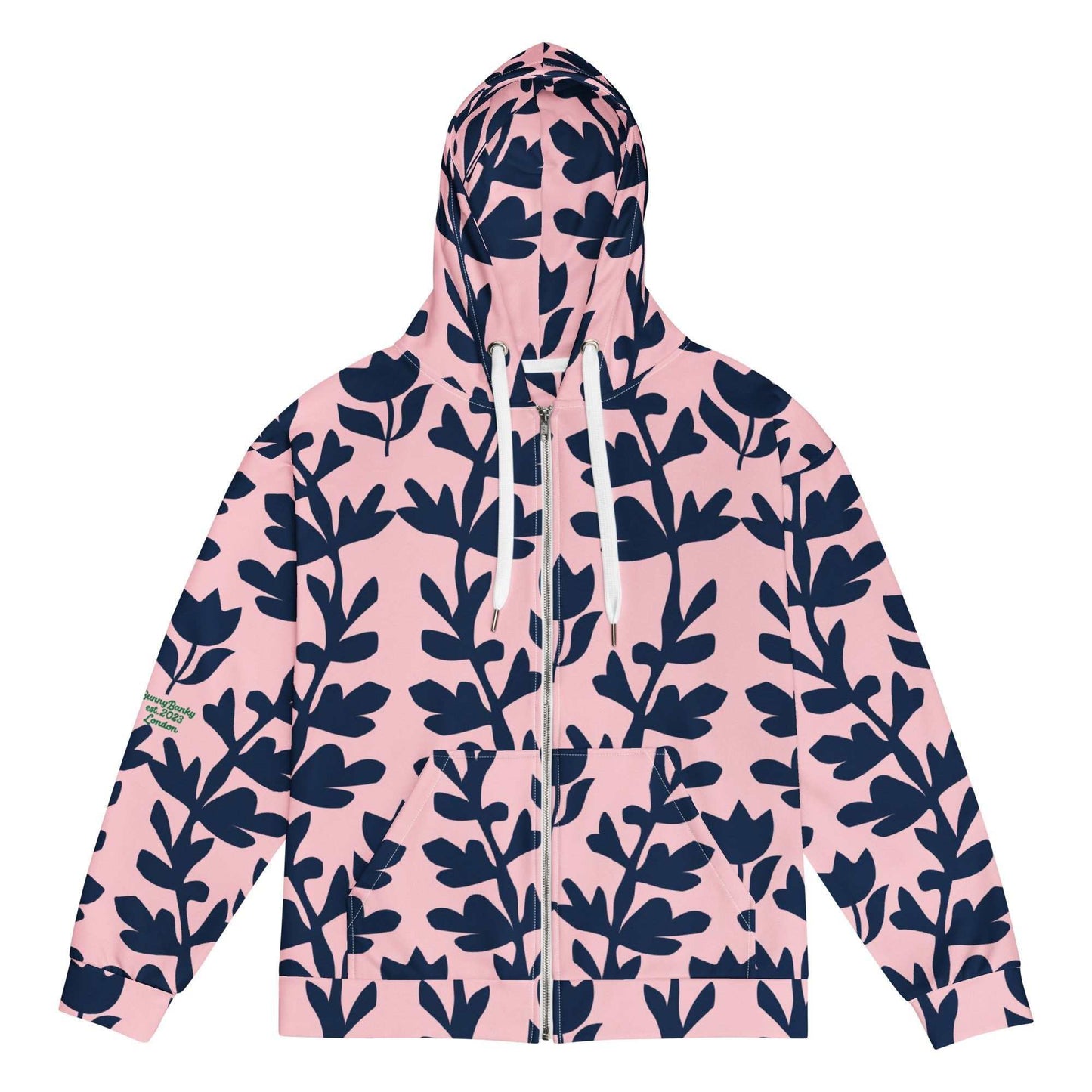 A model wearing The Kensington Zip Hoodie, showing the full-zip closure and the oversized pink and blue floral print across the recycled polyester fabric.
