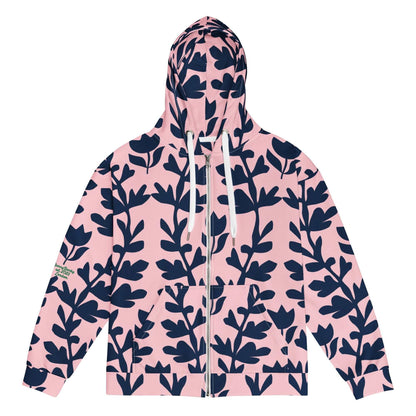 A model wearing The Kensington Zip Hoodie, showing the full-zip closure and the oversized pink and blue floral print across the recycled polyester fabric.