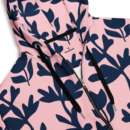 A model wearing The Kensington Zip Hoodie, showing the full-zip closure and the oversized pink and blue floral print across the recycled polyester fabric.