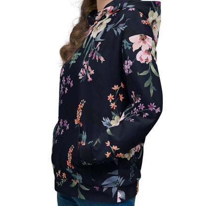 A model wearing the Kew Botanical Hoodie, highlighting the vibrant pink and violet floral details and the soft, premium drape of the recycled fabric.