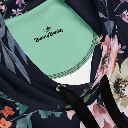 Front view of the Kew Botanical Hoodie against a white background, showcasing the intricate navy and blush wildflower print and the white BunnyBankY London arched branding.