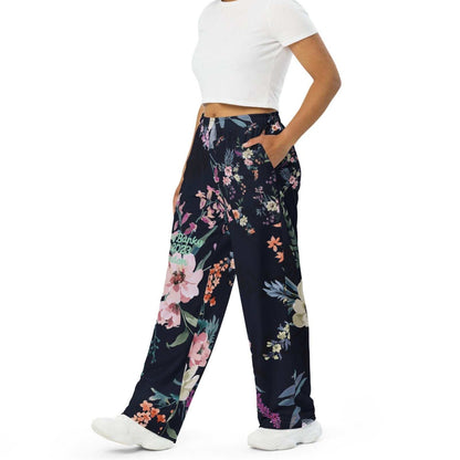 A model wearing the Kew Botanical Wide Leg Joggers. The image highlights the cohesive floral print across joggers, emphasizing the premium drape of the wide-leg cut.