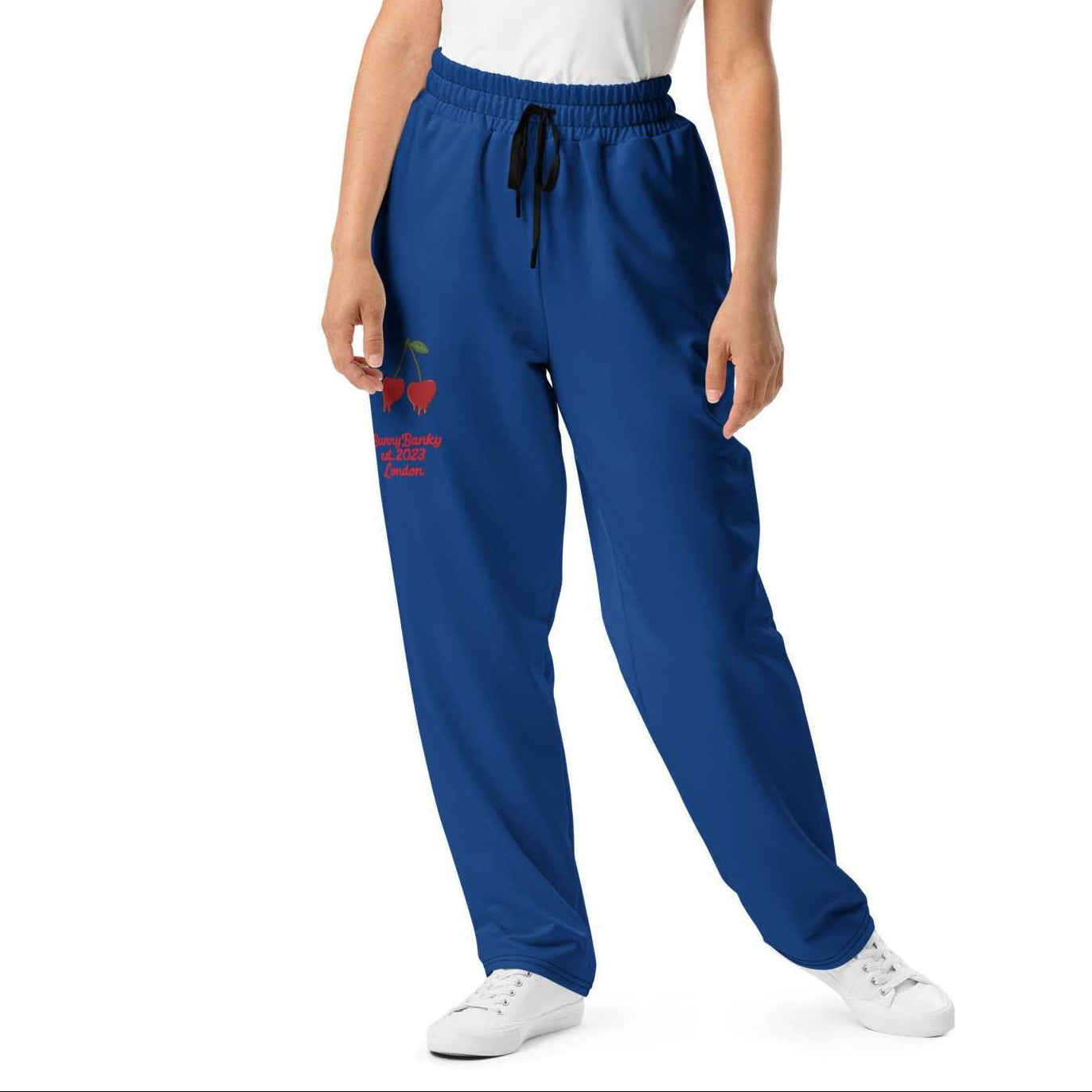 A model wearing The LA Navy Flow Joggers, showing the wide-leg cut, the playful Pop Cherry print, and the binary code on the dark navy fabric.