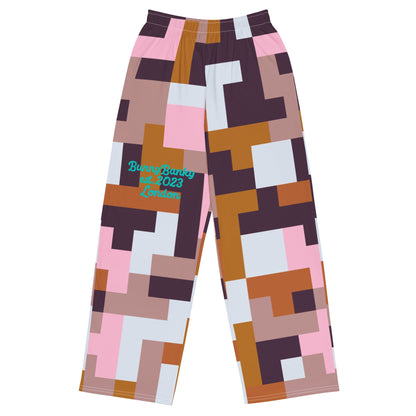 The Marais Flow Joggers. These joggers are high-waisted, wide-leg flowy joggers featuring the distinctive cubism-inspired geometric pattern made of interlocking pink, brown, dark purple, and white rectangular and square blocks. 