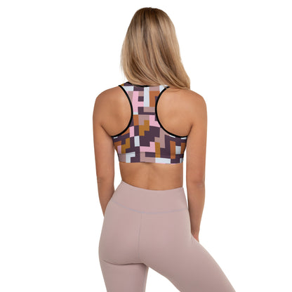 A model wearing The Marais Digital Atelier Performance Bra, showing the supportive fit and the sophisticated Cubism-inspired geometric print in pink, brown, and white.
