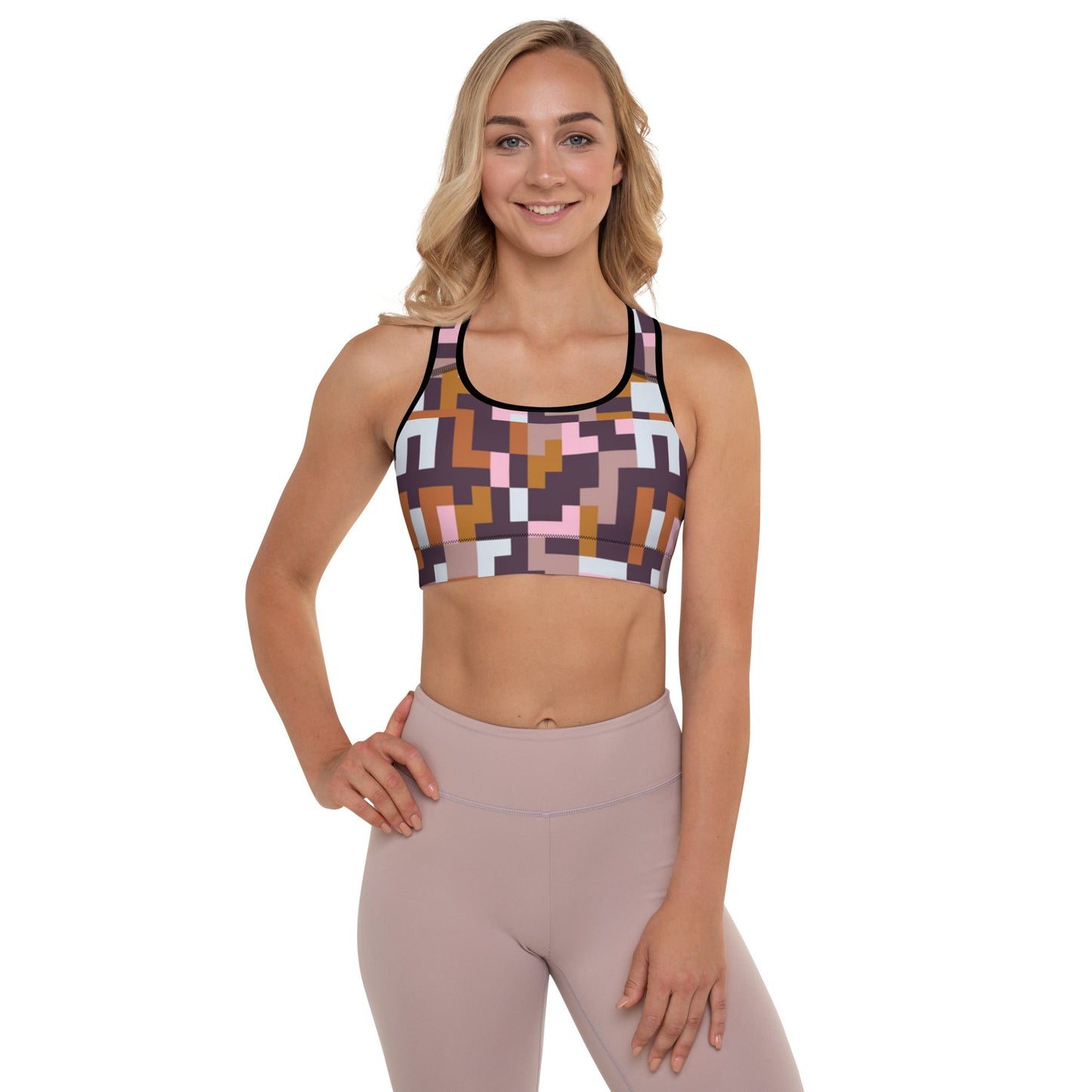 A model wearing The Marais  Performance Bra, showing the supportive fit and the sophisticated Cubism-inspired geometric print in pink, brown, and white.