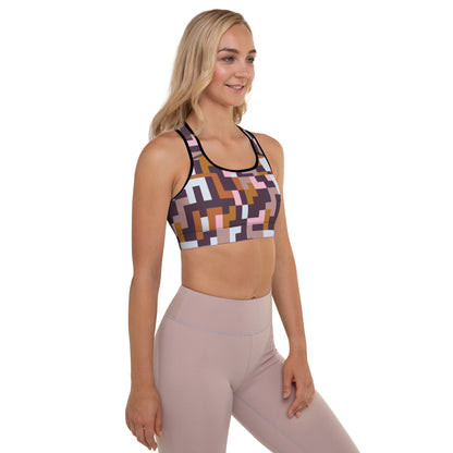 A model wearing The Marais Digital Atelier Performance Bra, showing the supportive fit and the sophisticated Cubism-inspired geometric print in pink, brown, and white.