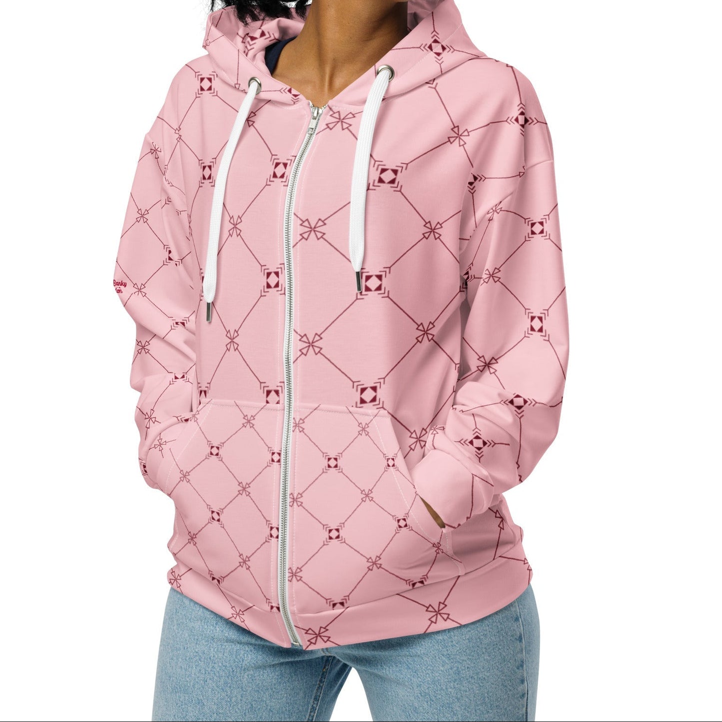 A model wearing the Mayfair Zip Hoodie, showing the unisex fit and the sophisticated burgundy and pink geometric monogram print.