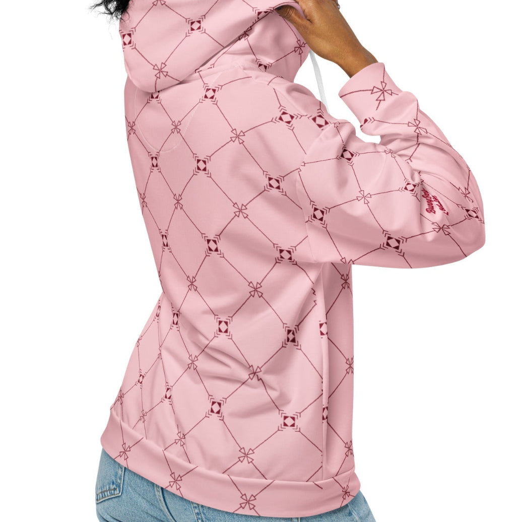 A model wearing the Mayfair Zip Hoodie, showing the unisex fit and the sophisticated burgundy and pink geometric monogram print.