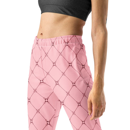 A model wearing the Mayfair  Slim Fit Joggers in the burgundy and pink geometric monogram print, showing the tailored fit and secured cuffs