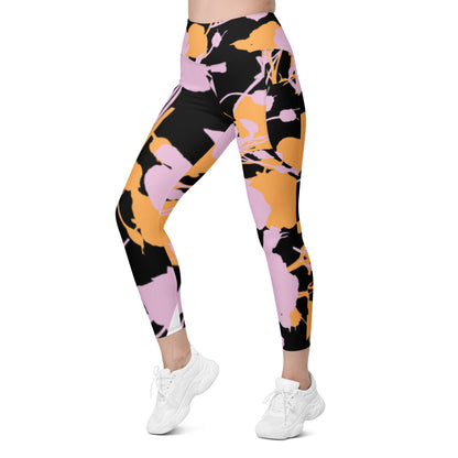 A model wearing The Miami Sculpt Leggings, showing the sculpting fit and the dynamic pink and orange splashes print on the black fabric.
