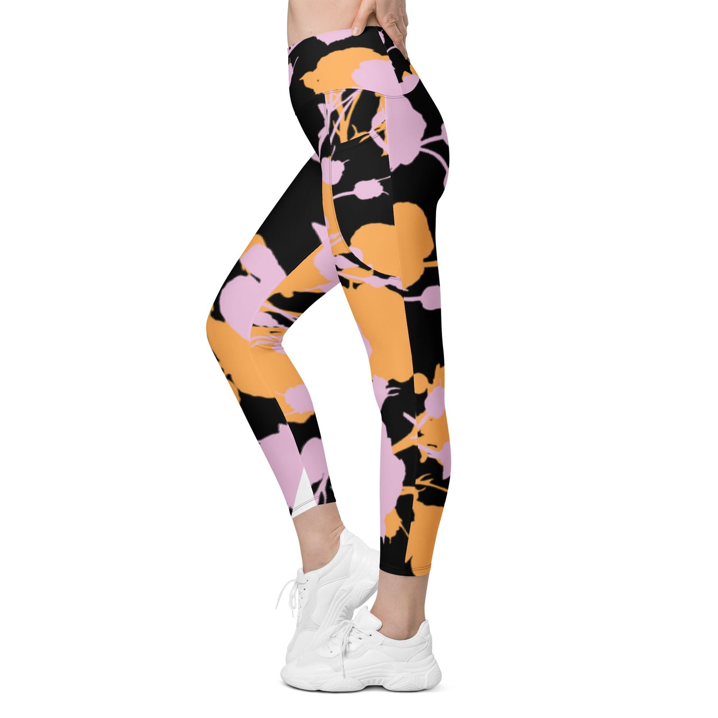 A model wearing The Miami Sculpt Leggings, showing the sculpting fit and the dynamic pink and orange splashes print on the black fabric.