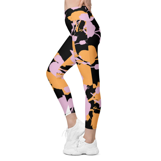 A model wearing The Miami Sculpt Leggings, showing the sculpting fit and the dynamic pink and orange splashes print on the black fabric.