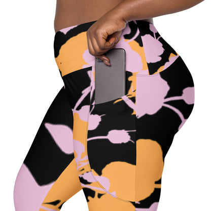 A model wearing The Miami Sculpt Leggings, showing the sculpting fit and the dynamic pink and orange splashes print on the black fabric.