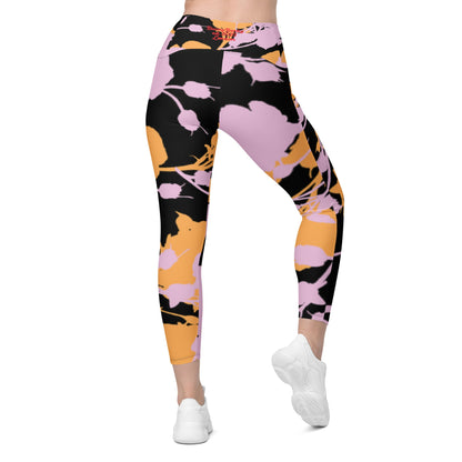 A model wearing The Miami Sculpt Leggings, showing the sculpting fit and the dynamic pink and orange splashes print on the black fabric.