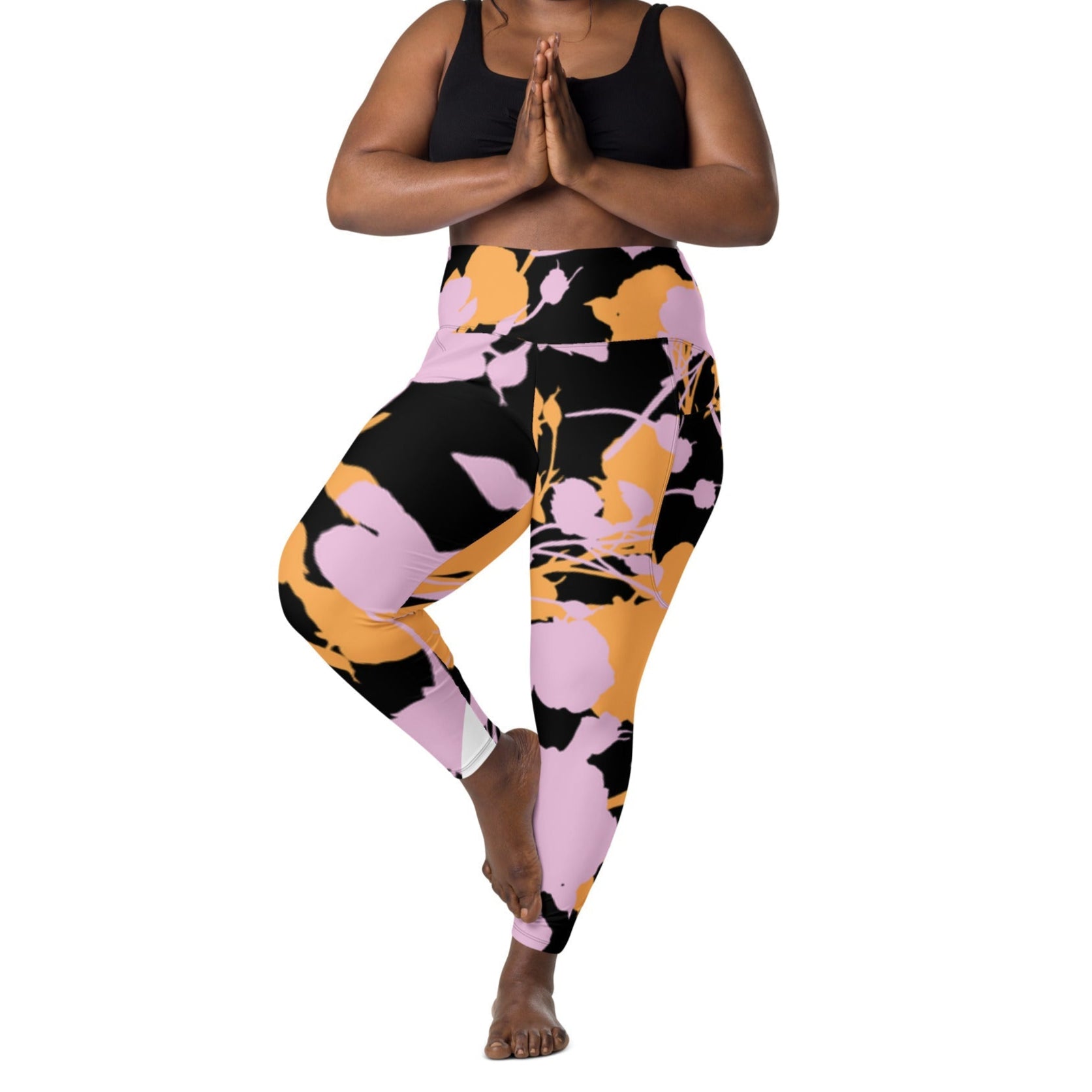 A model wearing The Miami Sculpt Leggings, showing the sculpting fit and the dynamic pink and orange splashes print on the black fabric.