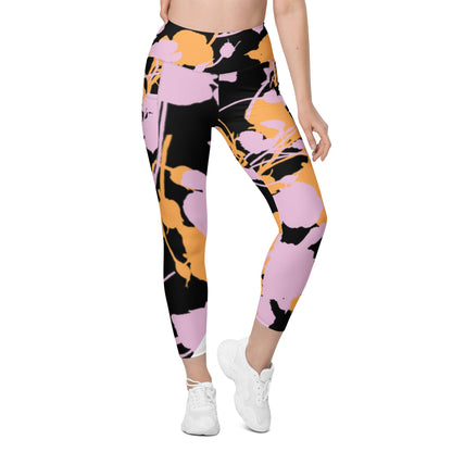 A model wearing The Miami Sculpt Leggings, showing the sculpting fit and the dynamic pink and orange splashes print on the black fabric.