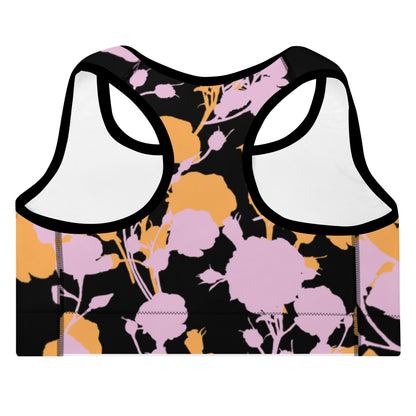 A close up of The Miami Performance Bra, showing the supportive fit and the vibrant pink and orange splashes print.