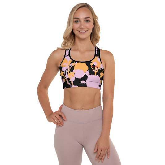 A model wearing The Miami Performance Bra, showing the supportive fit and the vibrant pink and orange splashes print.