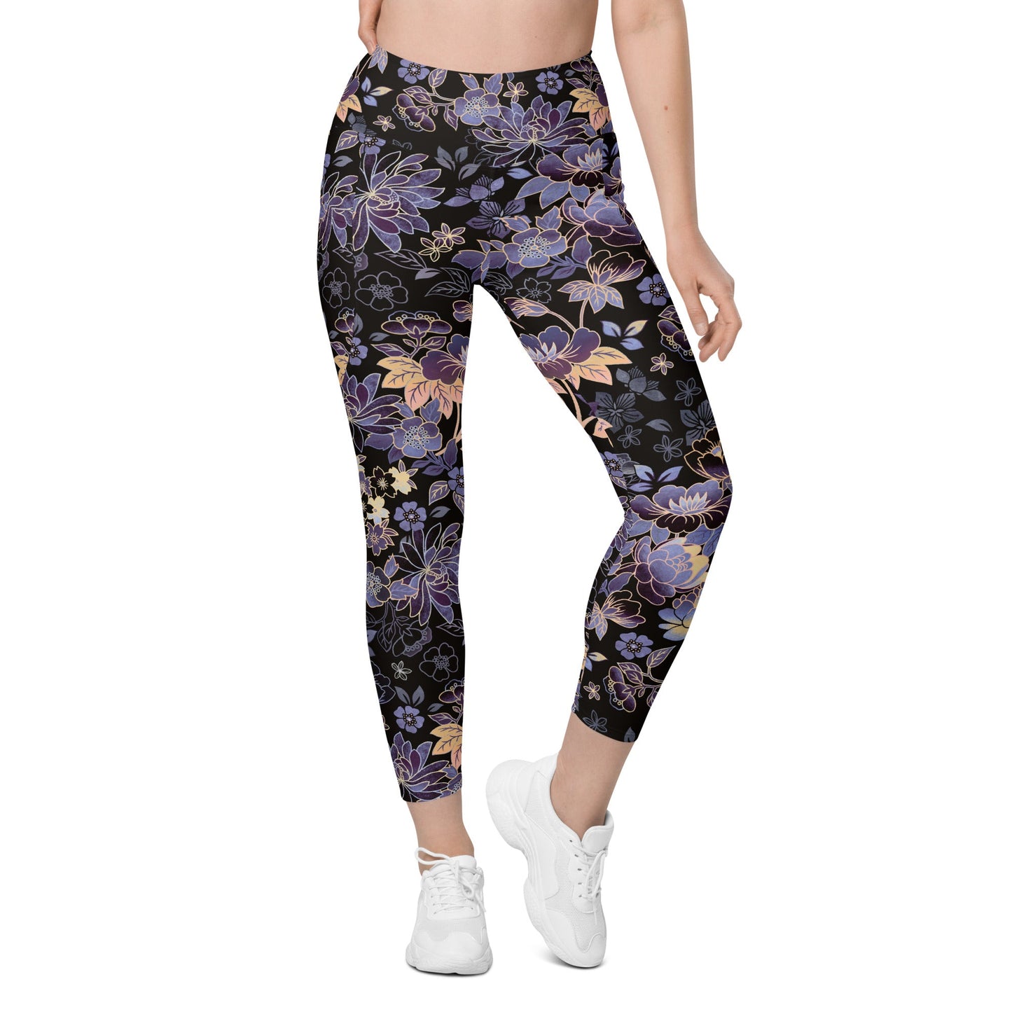 Model wearing the Milano sculpt leggings in purple and beige floral pattern on a black fabric.