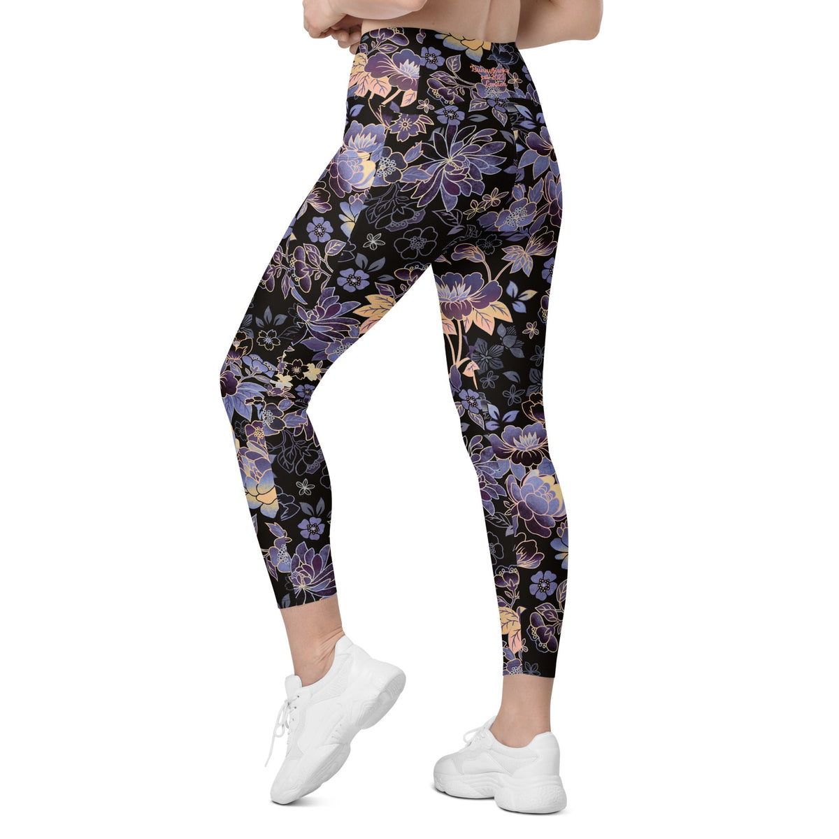 Model wearing the Milano sculpt leggings in purple and beige floral pattern on a black fabric.