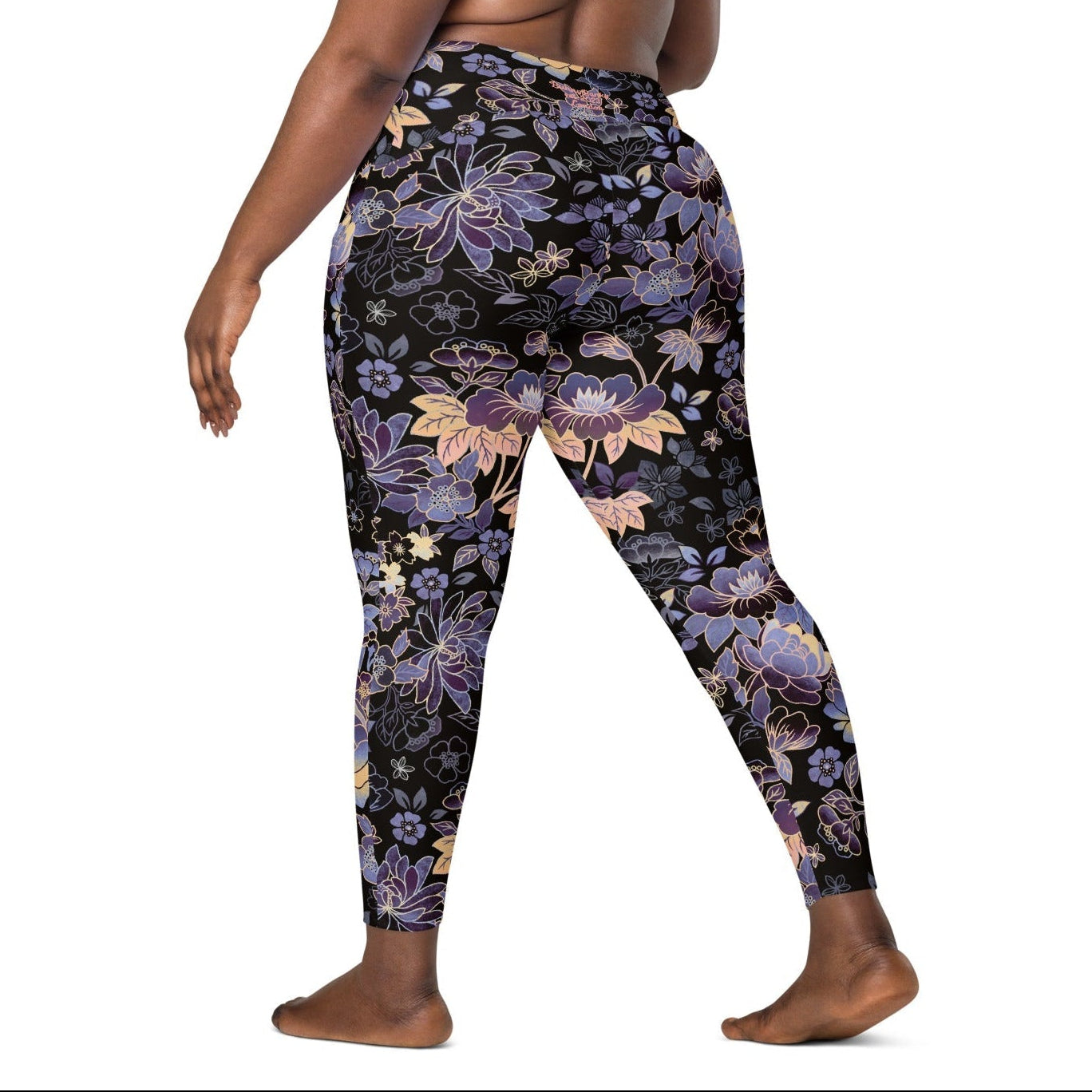 Model wearing the Milano sculpt leggings in purple and beige floral pattern on a black fabric.