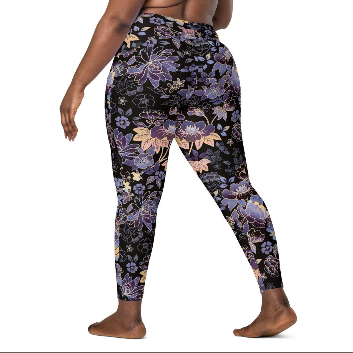Model wearing the Milano sculpt leggings in purple and beige floral pattern on a black fabric.