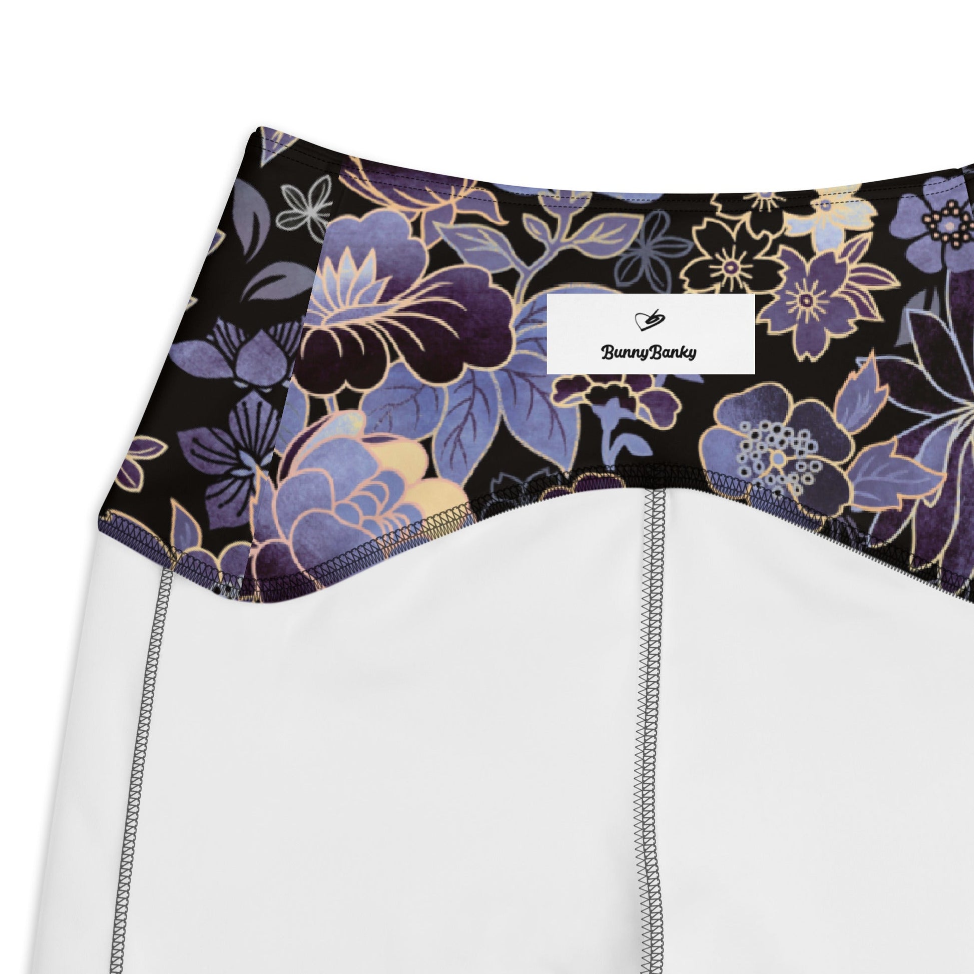 detail of the inside of the Milano sculpt leggings in purple and beige floral pattern on a black fabric.