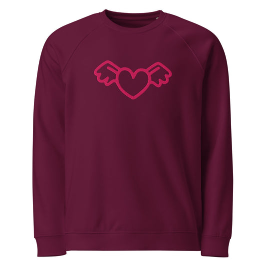 A close-up of The Monument Organic Sweatshirt, showing the detailed embroidery of a vibrant pink heart with wings on the 100% organic cotton fabric.