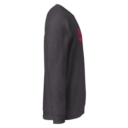 A close-up of The Monument Organic Sweatshirt, showing the detailed embroidery of a vibrant pink heart with wings on the 100% organic cotton fabric.