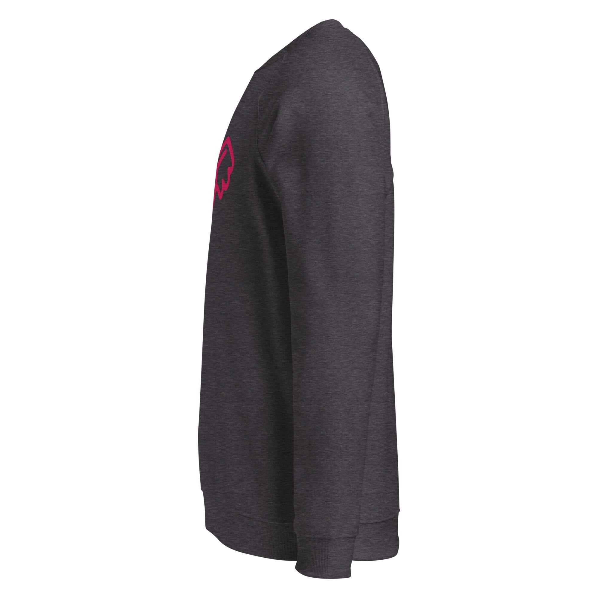 A close-up of The Monument Organic Sweatshirt, showing the detailed embroidery of a vibrant pink heart with wings on the 100% organic cotton fabric.