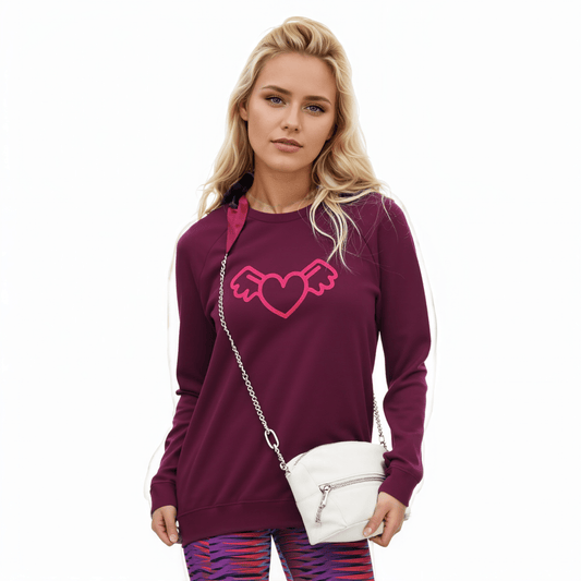 A model wearing The Monument Organic Sweatshirt, showing the relaxed, premium fit and the "Winged Heart" embroidery in vibrant pinkand The Moorgate Sculpt Leggigns.