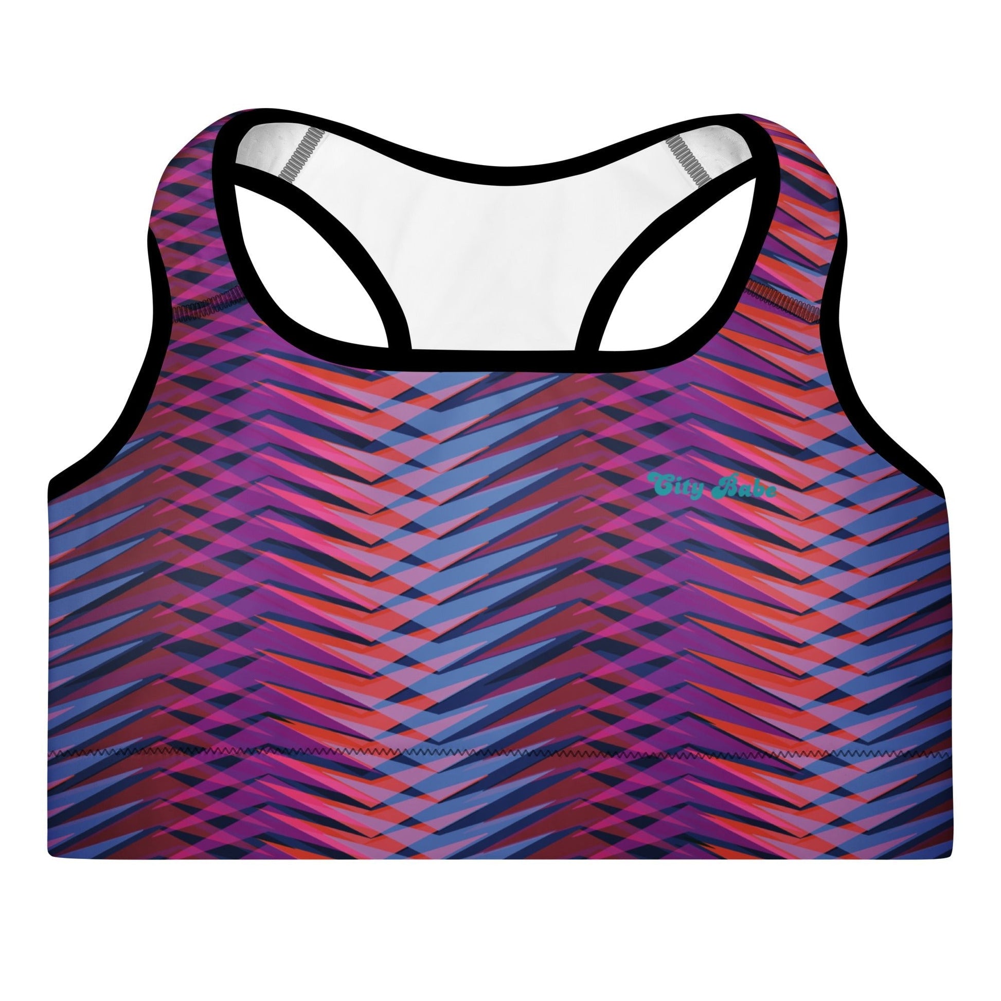 A close-up of The Moorgate Performance Bra's graphic arrow print, showing the premium recycled fabric and the "graphic knit" pattern of pink, orange, and blue.