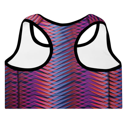A close-up of The Moorgate Performance Bra's graphic arrow print, showing the premium recycled fabric and the "graphic knit" pattern of pink, orange, and blue.