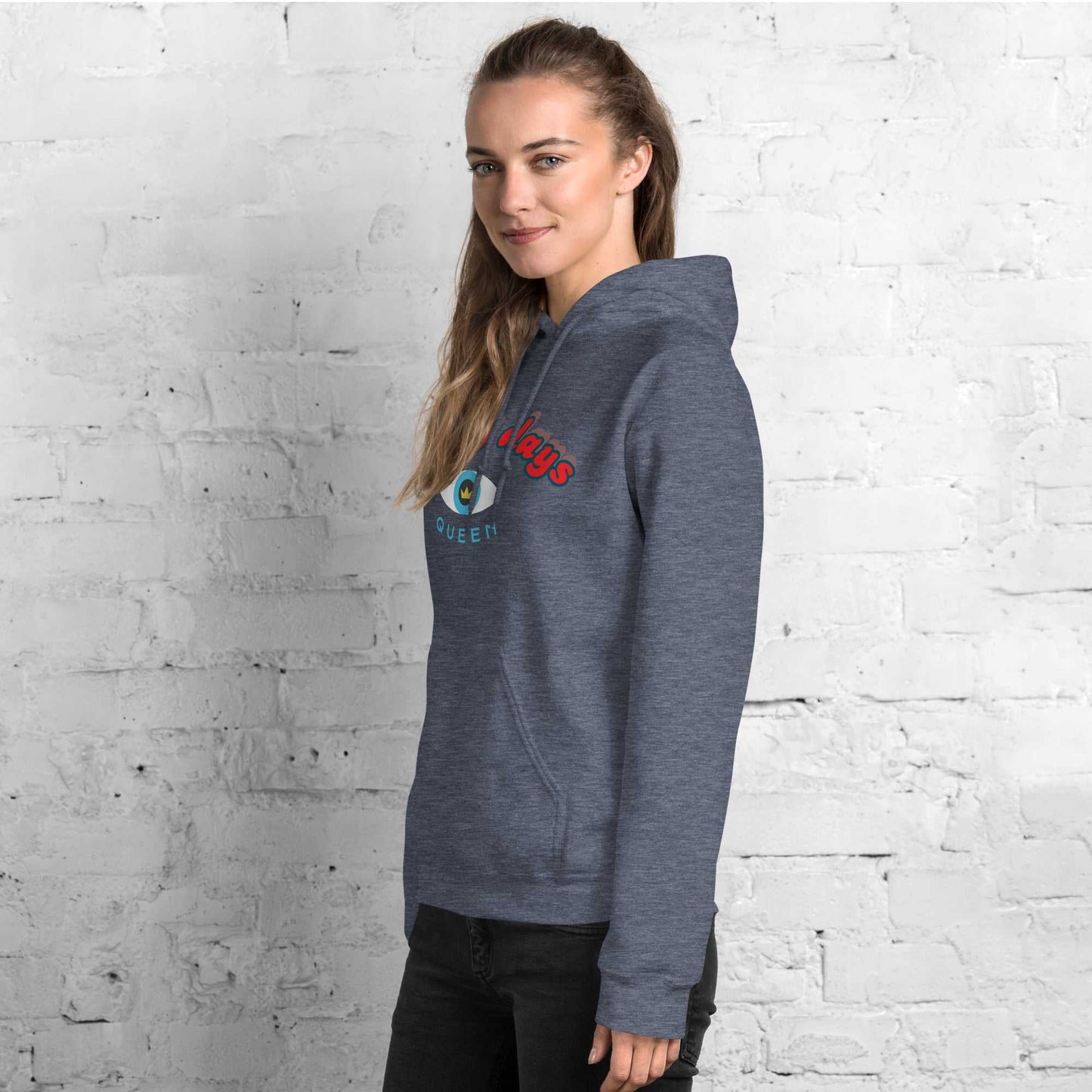 A model wearing The Mykonos Hoodie, showing the relaxed fit, drawstring hood, and the  Crown and "Queen" print on the front center.
