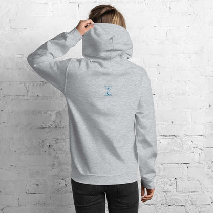 A model wearing The Mykonos Hoodie, showing the relaxed fit, drawstring hood, and the embroidered Crown and "Queen" print on the front center.