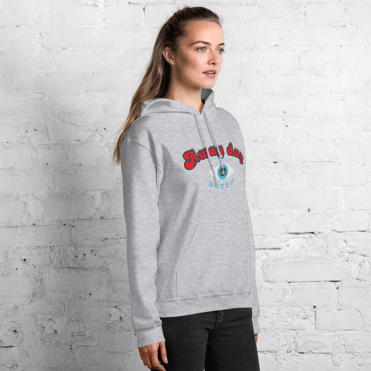 A model wearing The Mykonos Hoodie, showing the relaxed fit, drawstring hood, and the  Crown and "Queen" print on the front center.