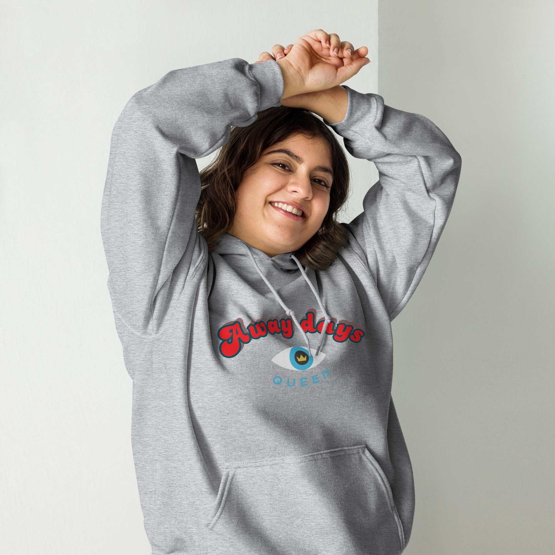 A model wearing The Mykonos Hoodie, showing the relaxed fit, drawstring hood, and the  Crown and "Queen" print on the front center.
